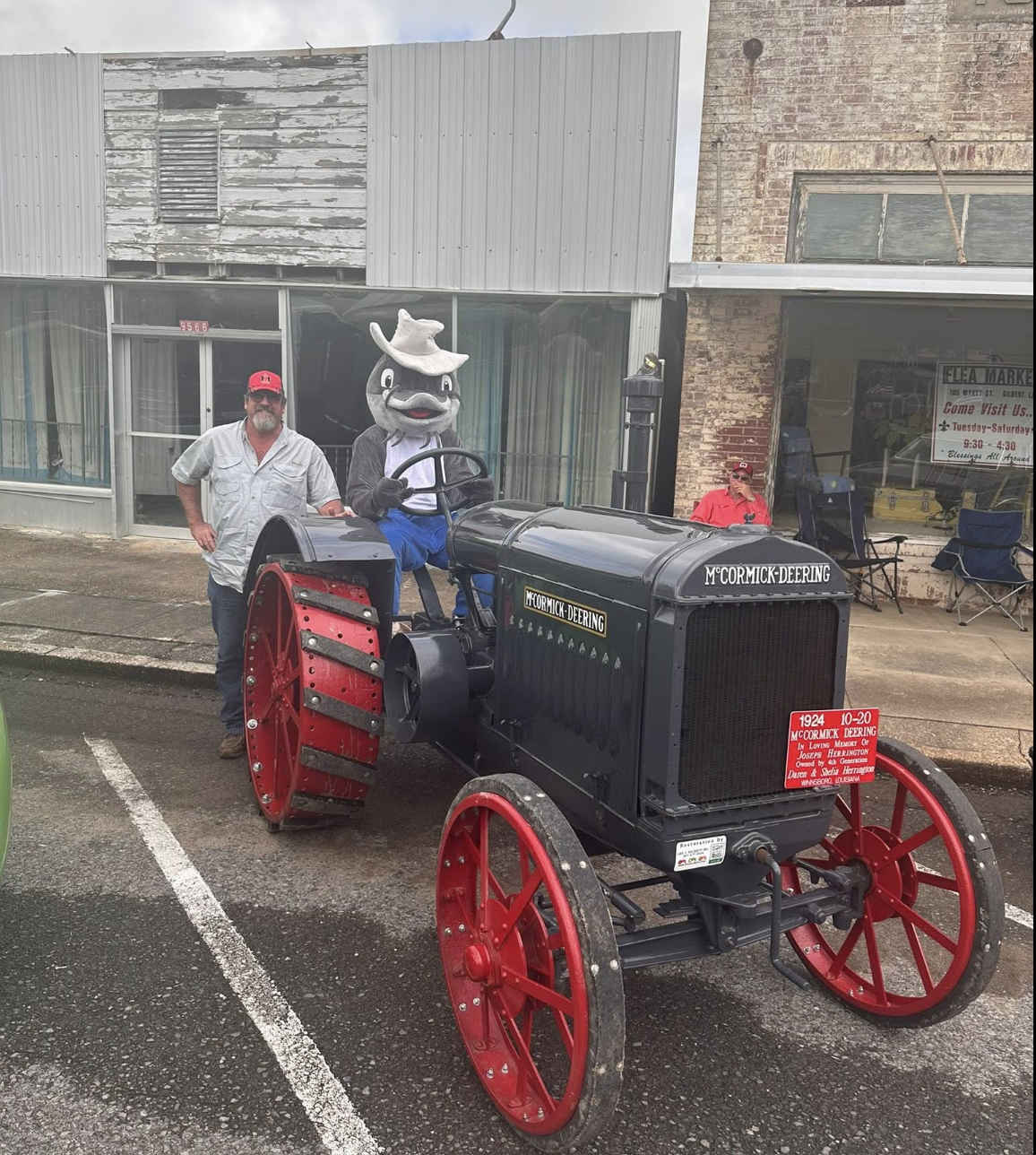 Mascot riding the McCormick-Deering antique tractor
